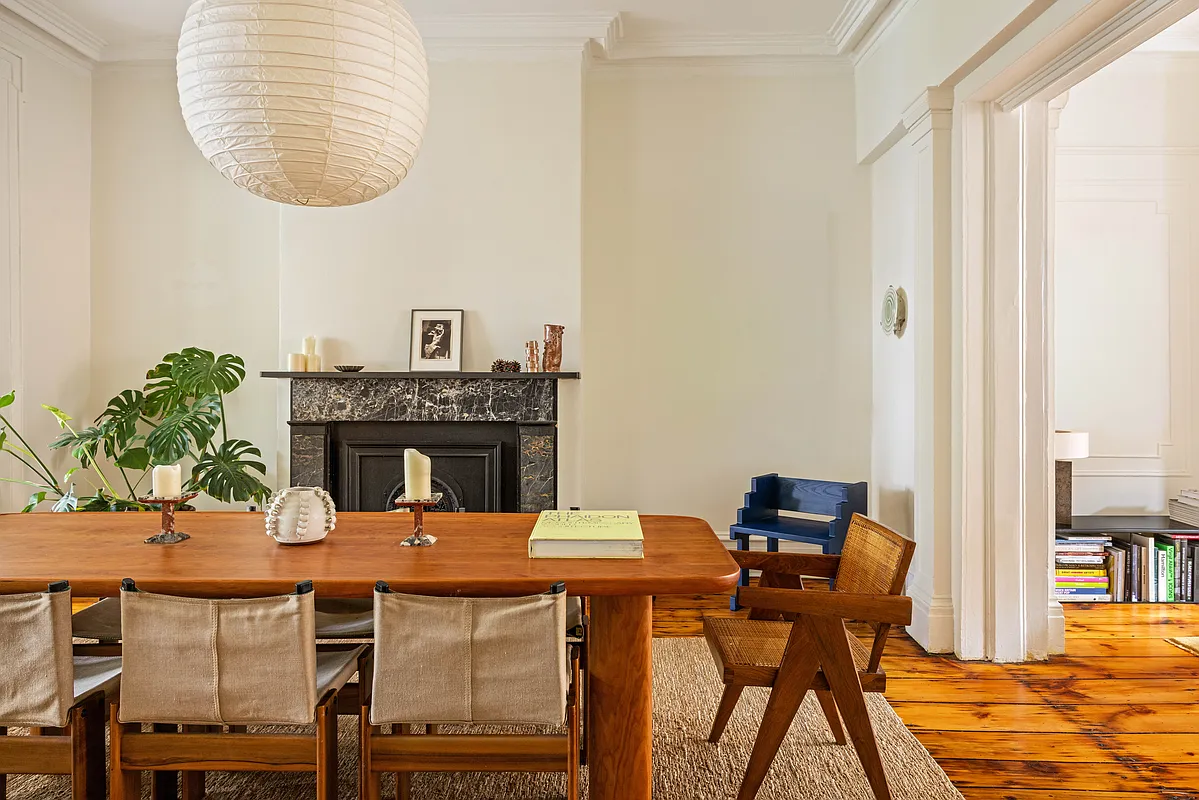dining room with wood floor, black marble mantel