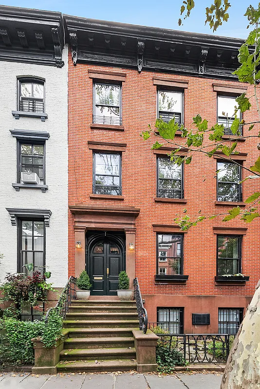 brick row house exterior with a wide brownstone stoop