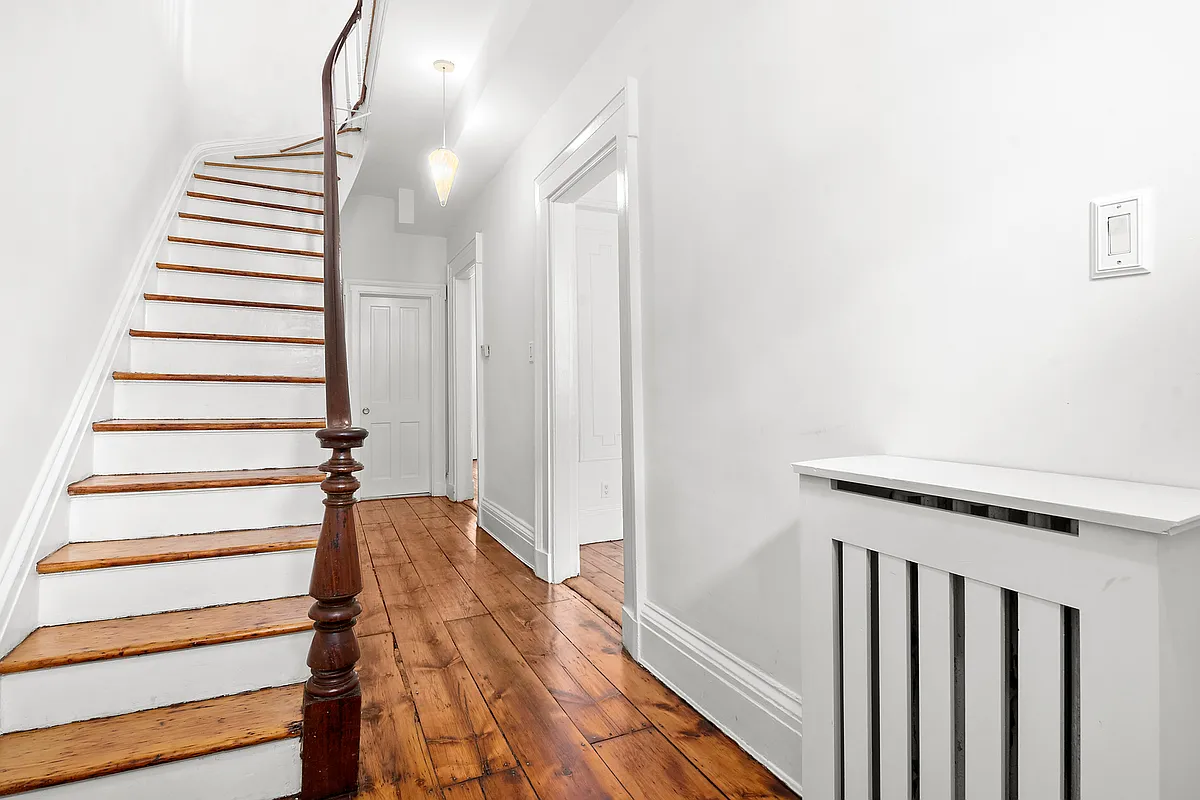 entry hall with wood floor, original staircase with curved rail