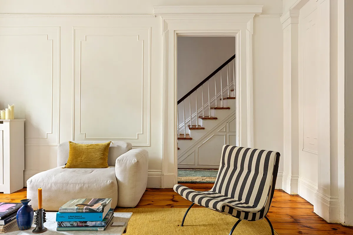 parlor with wall moldings and view into entry hall