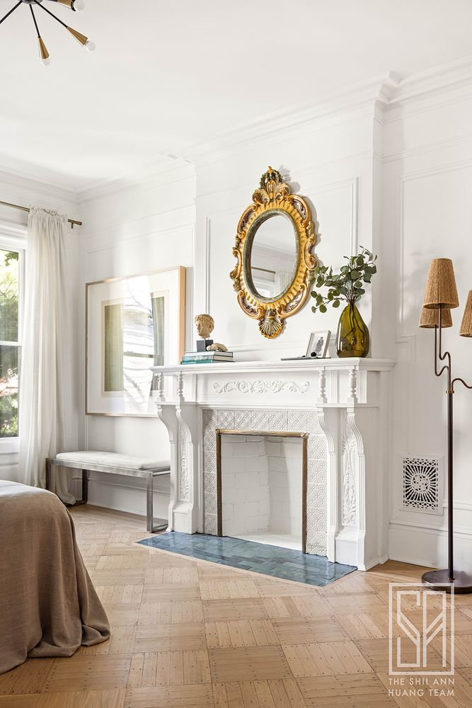 bedroom mantel painted white and with white tile surround