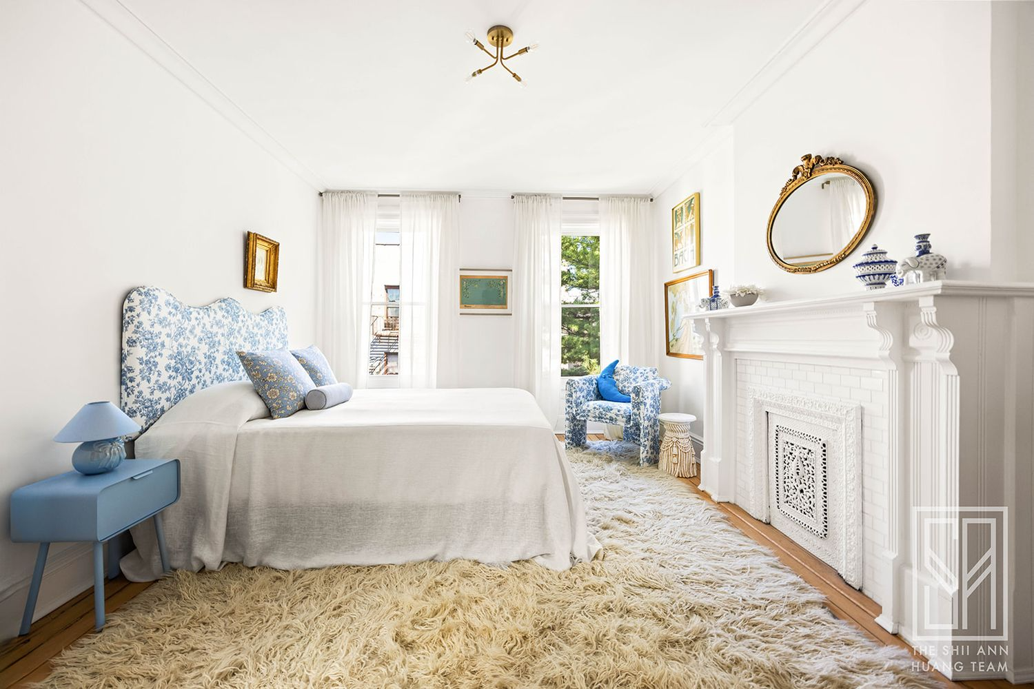 bedroom with two windows, white mantel