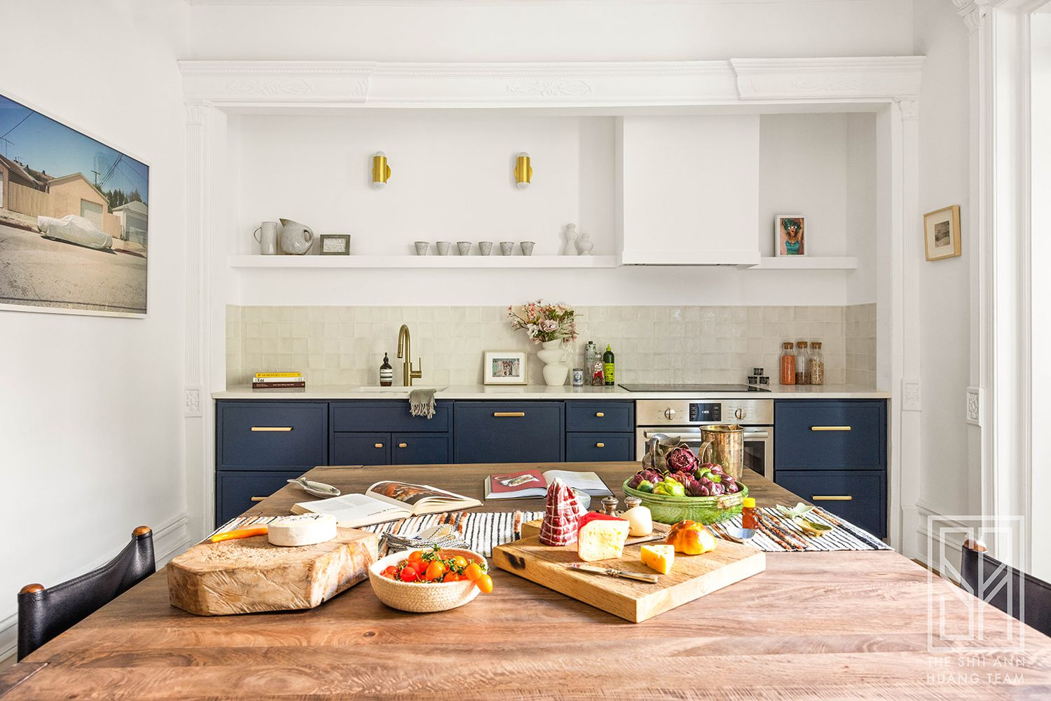 open plan kitchen and dining with blue lower cabinets