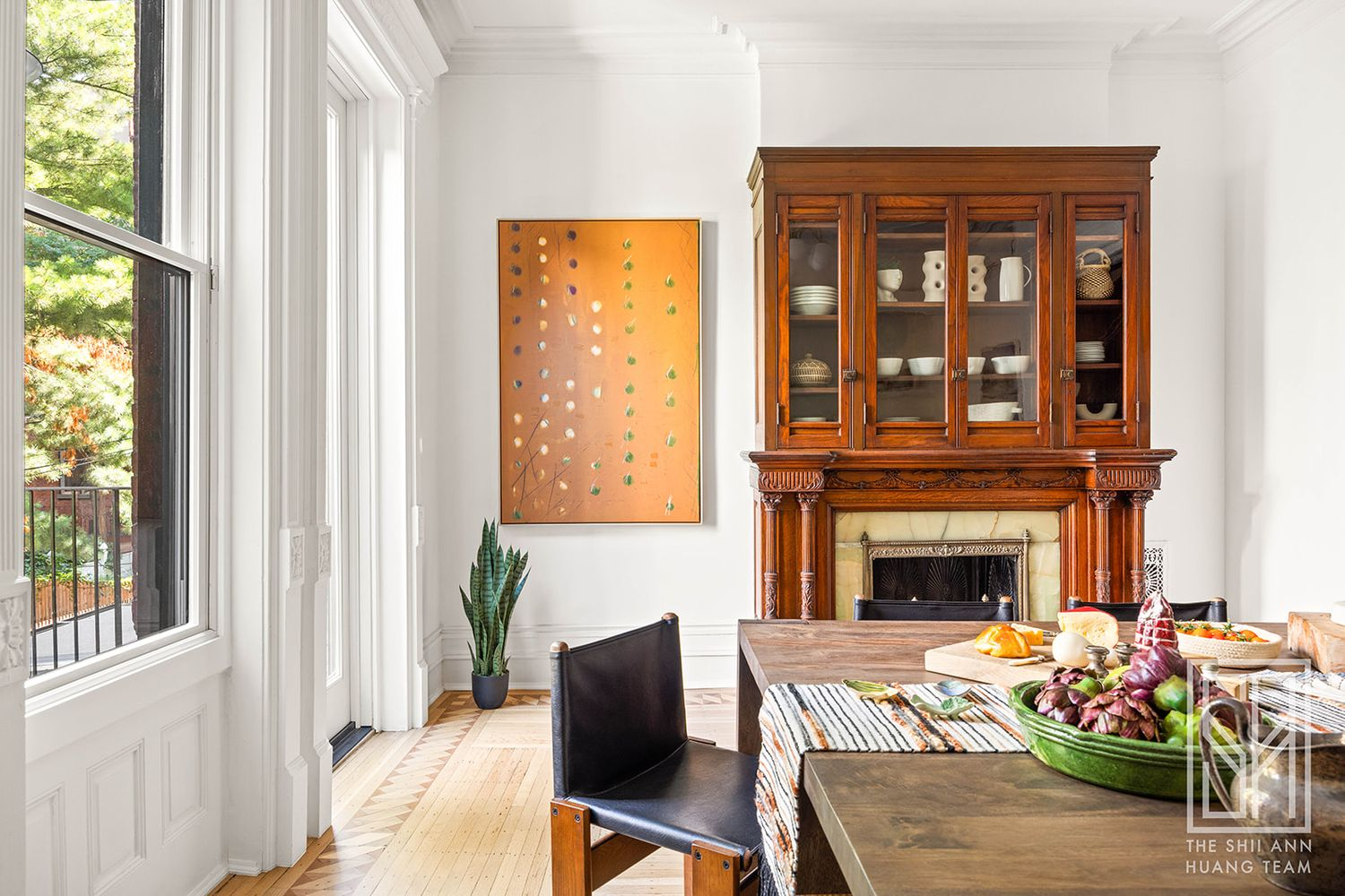 dining area in kitchen with mantel with glass-doored cabinet above