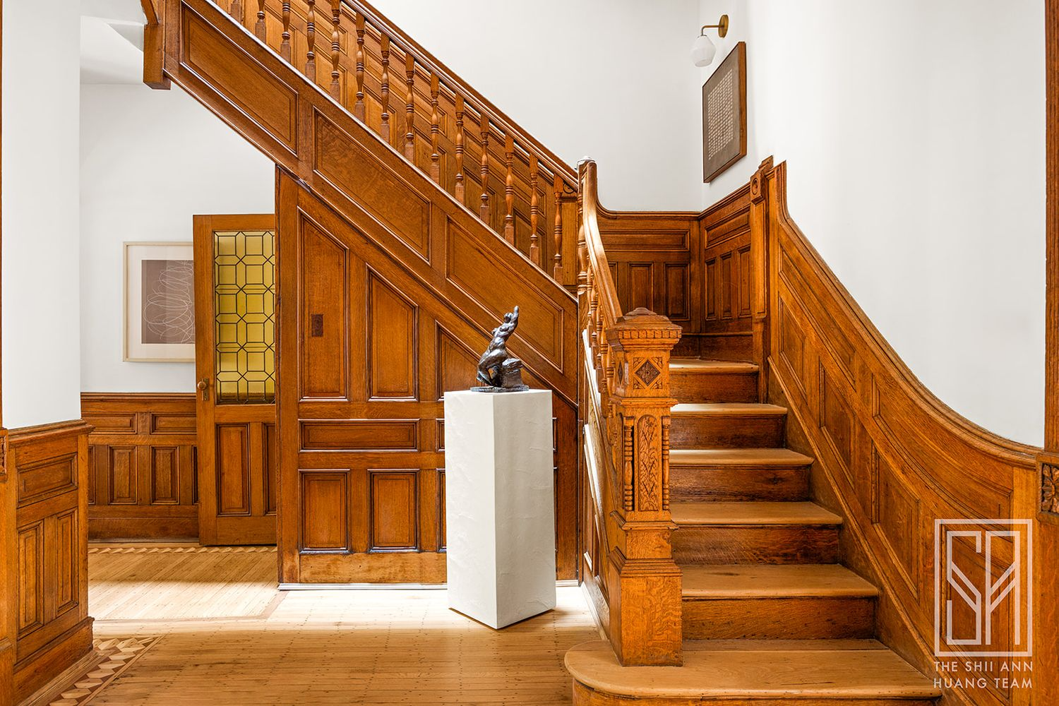 stair with wainscoting, ornate newel post