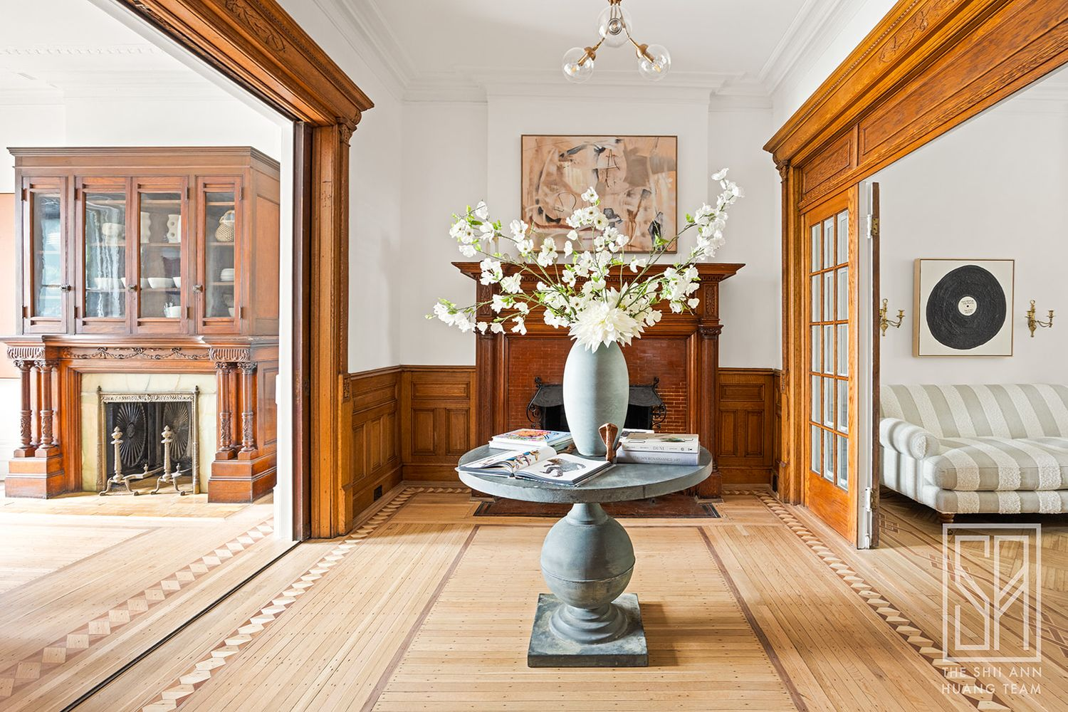 middle parlor with view of mantel and another mantel in the dining room