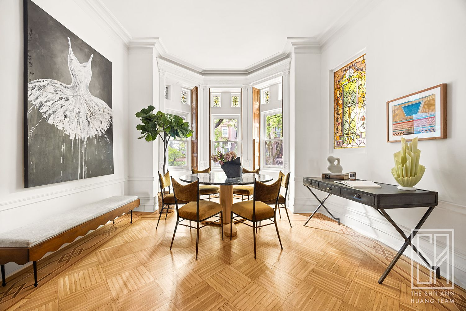 front parlor with dining area set up in the bay window