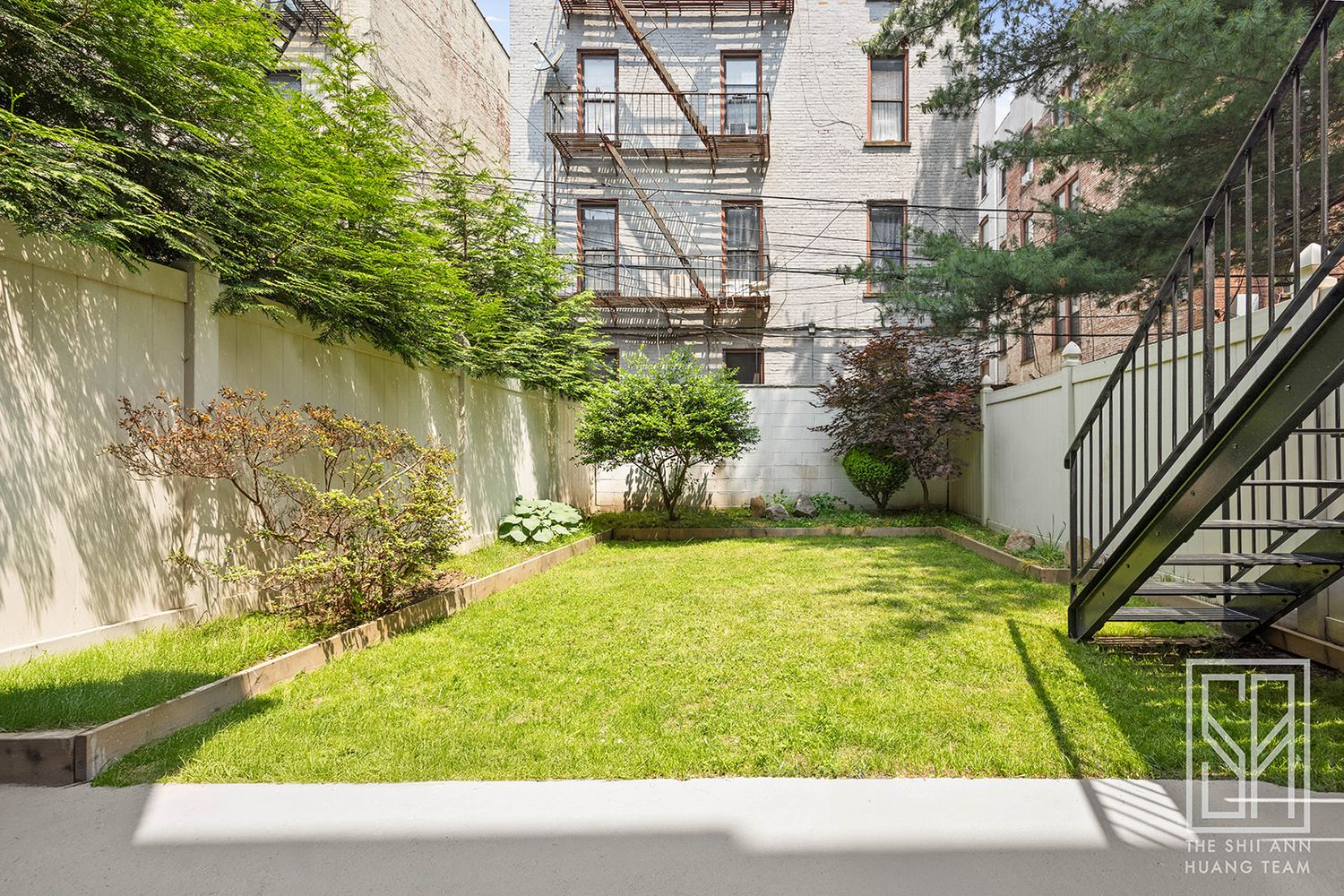 yard with lawn and planting beds