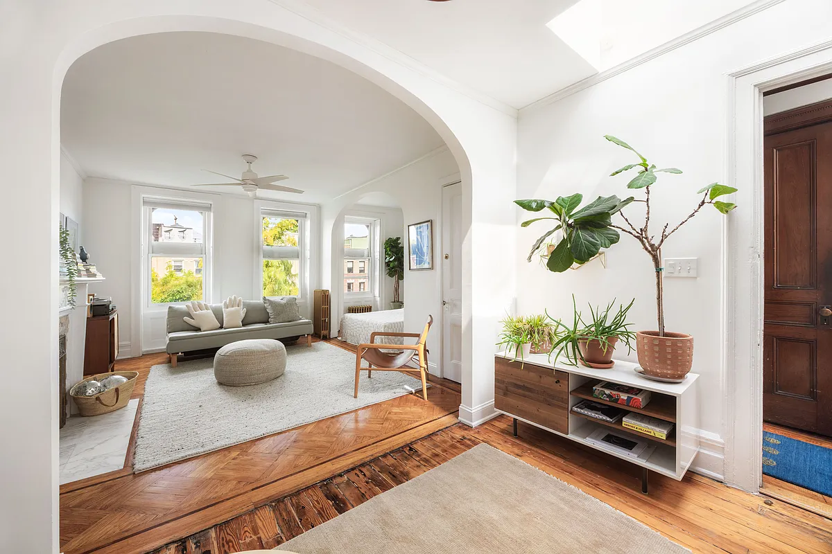 bedroom with wood floor, bed alcove