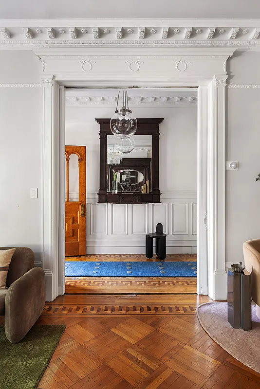 view of pilaster framed doorway from parlor to the entry with all trim painted white