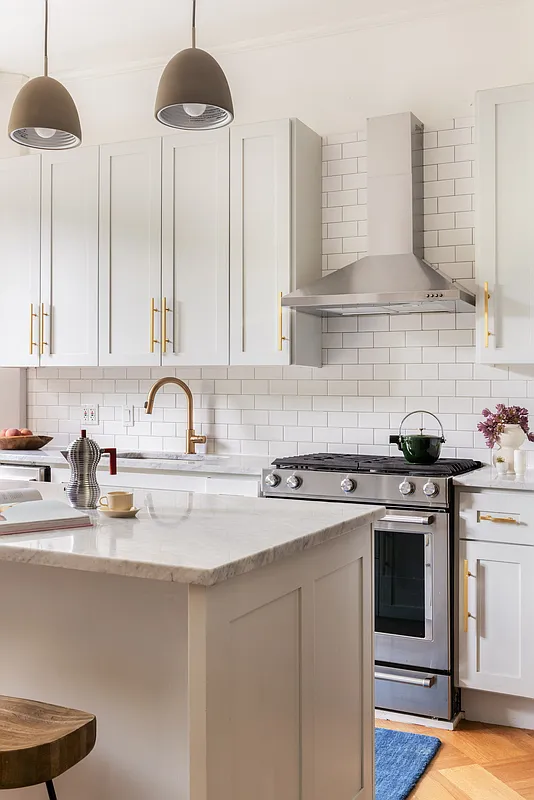 kitchen with white subway tile, white cabinets