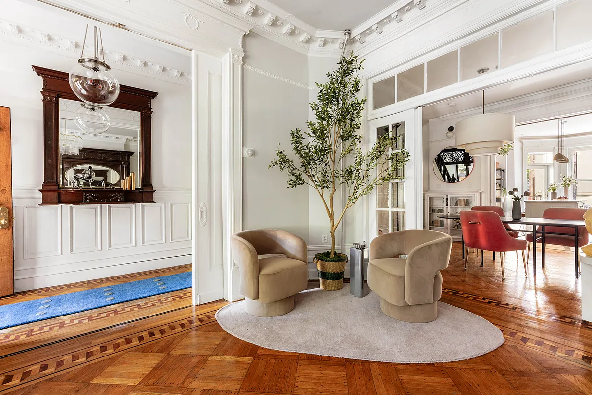 parlor with view into dining room with doorway with transom