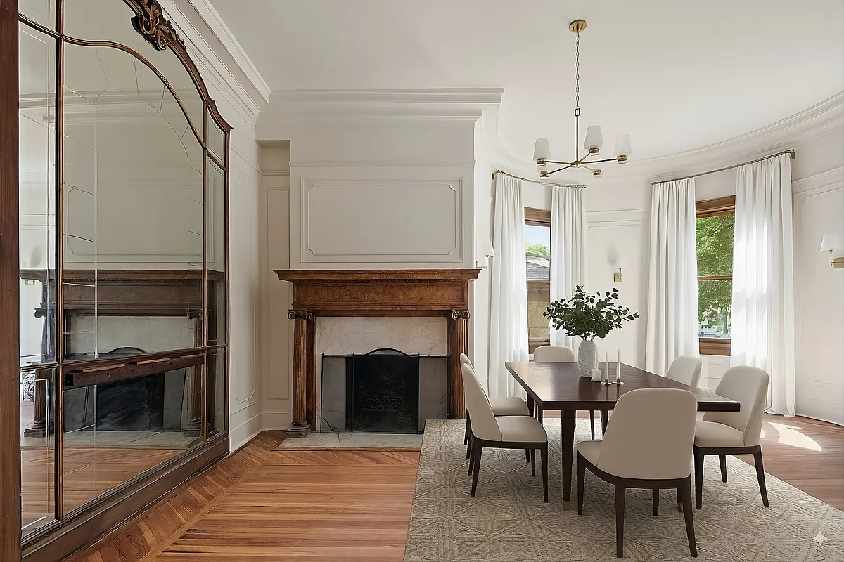 dinin groom with mirrored wall, mantel and white walls with wall moldings