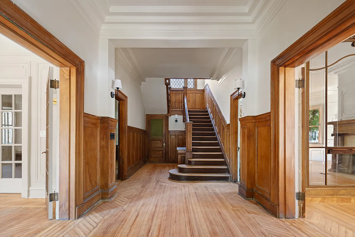 entry with original stair with wainscoting