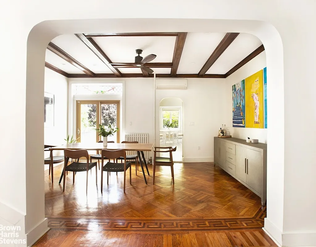 dining room with arched doorway, beamed ceiling and glass doors to the rear yard