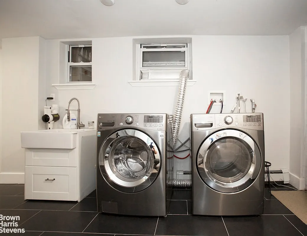 laundry room with full sized machines and a slop sink