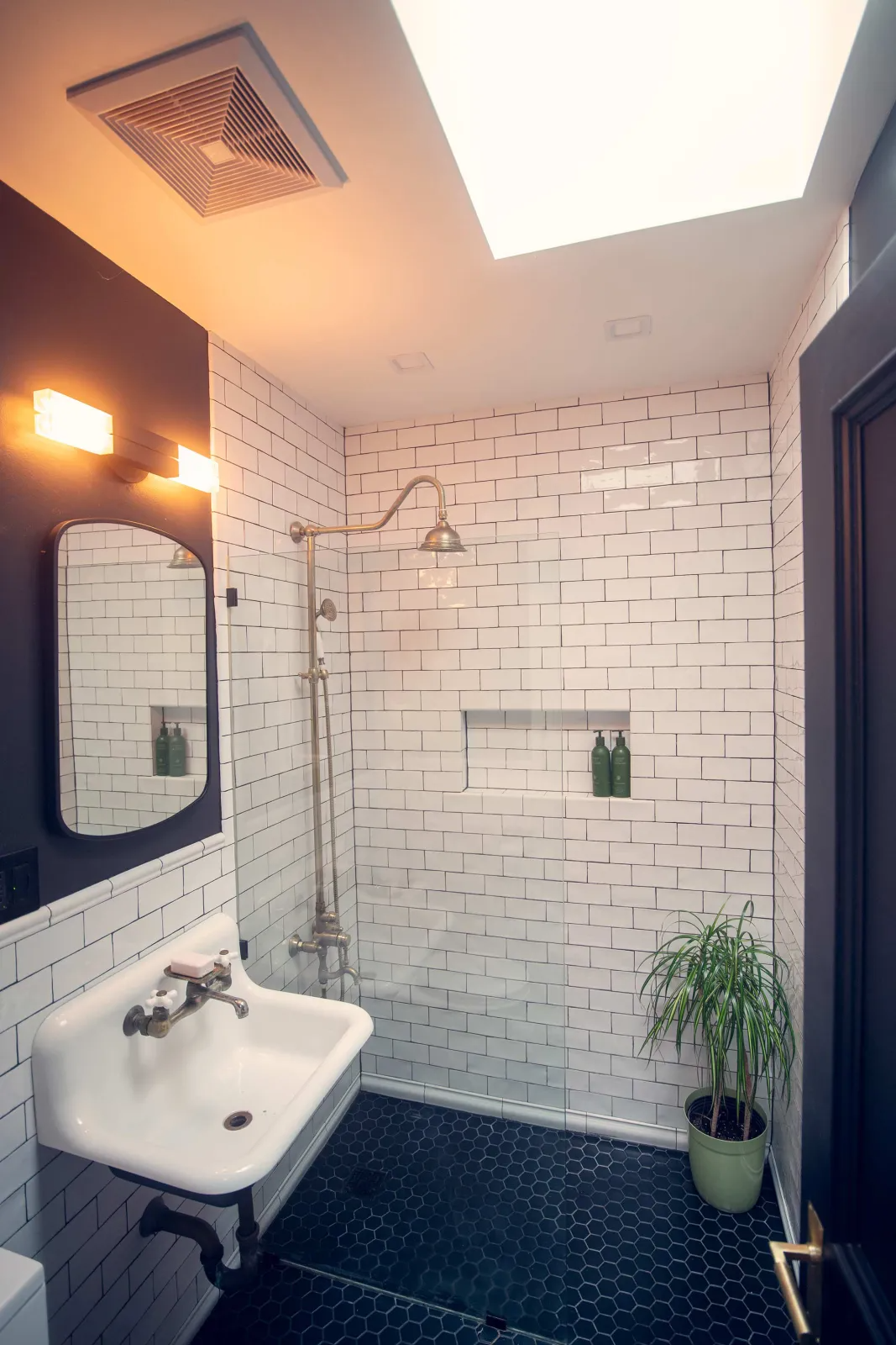 bathroom with a walk-in shower with white subway tile walls
