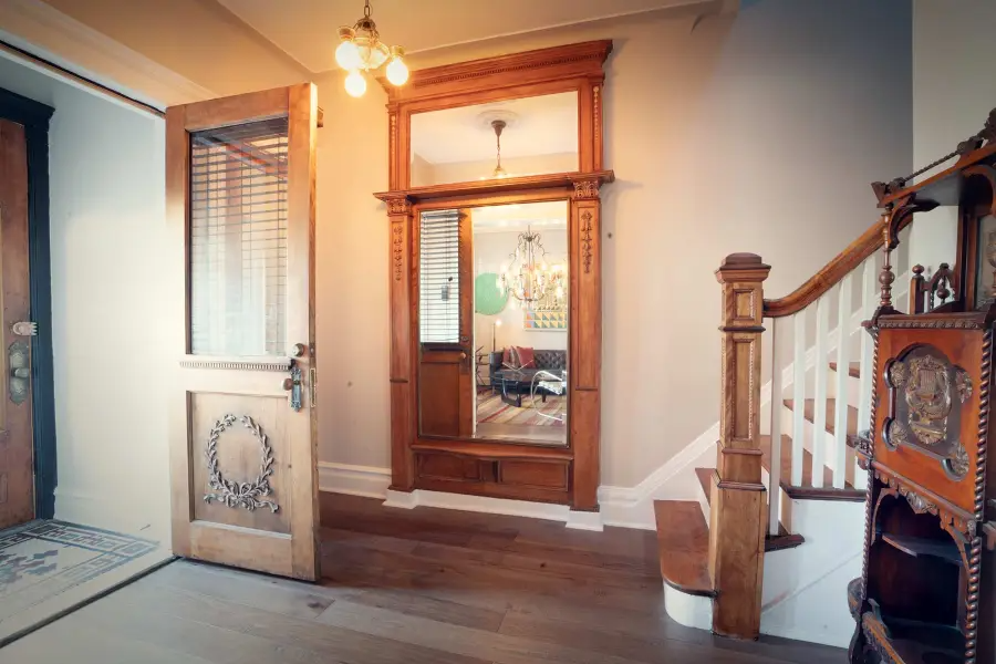 entry foyer with a mirror and a staircase