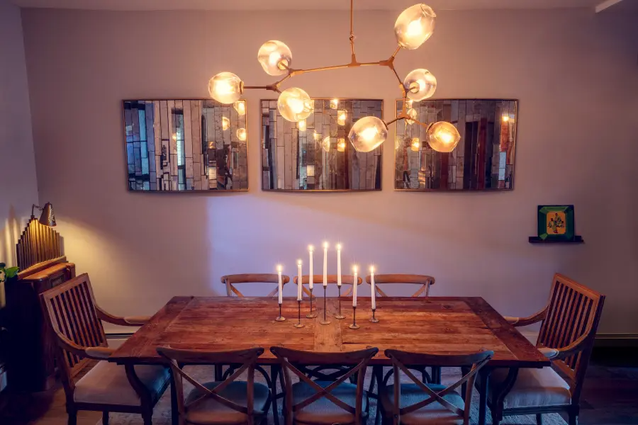 brass and glass chandelier above a dining room table