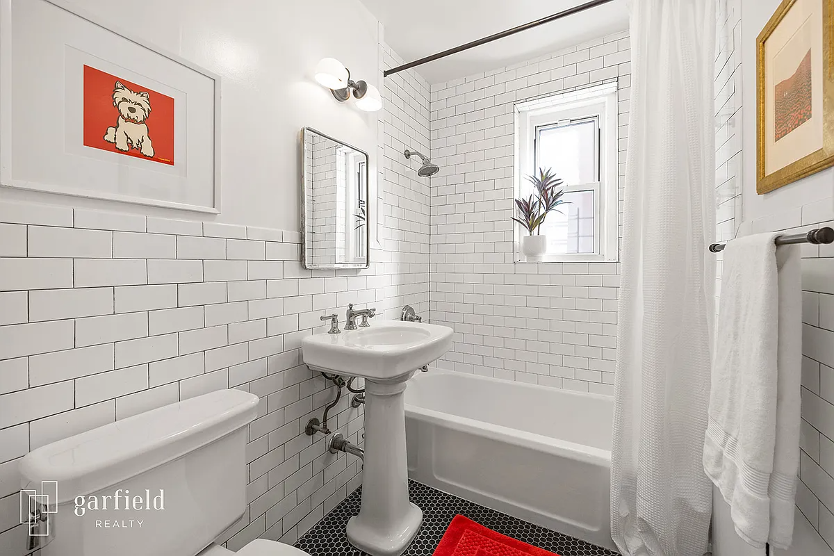 bathroom with white subway tiles and white fixtures