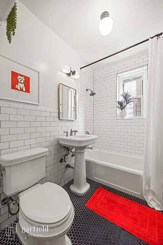 bathroom with white fixtures and white subway tiles on the walls