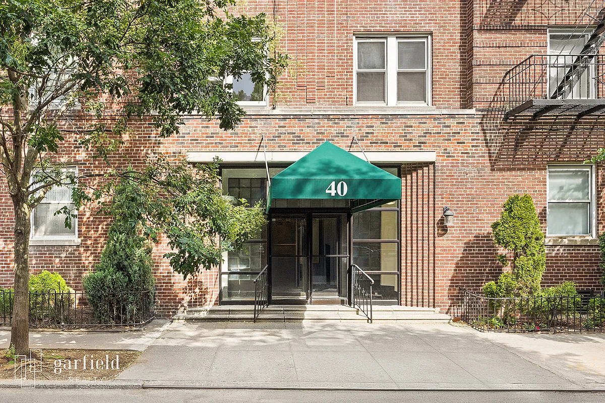 brick building with green awning with the number 40 on it