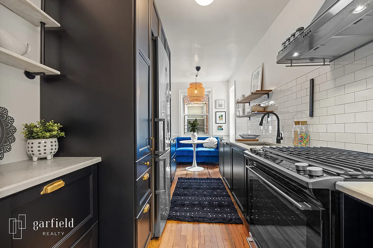 kitchen with dark cabinets, white subway tiles and room for eating