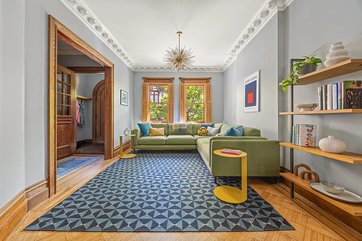 parlor with wood floor and crown molding