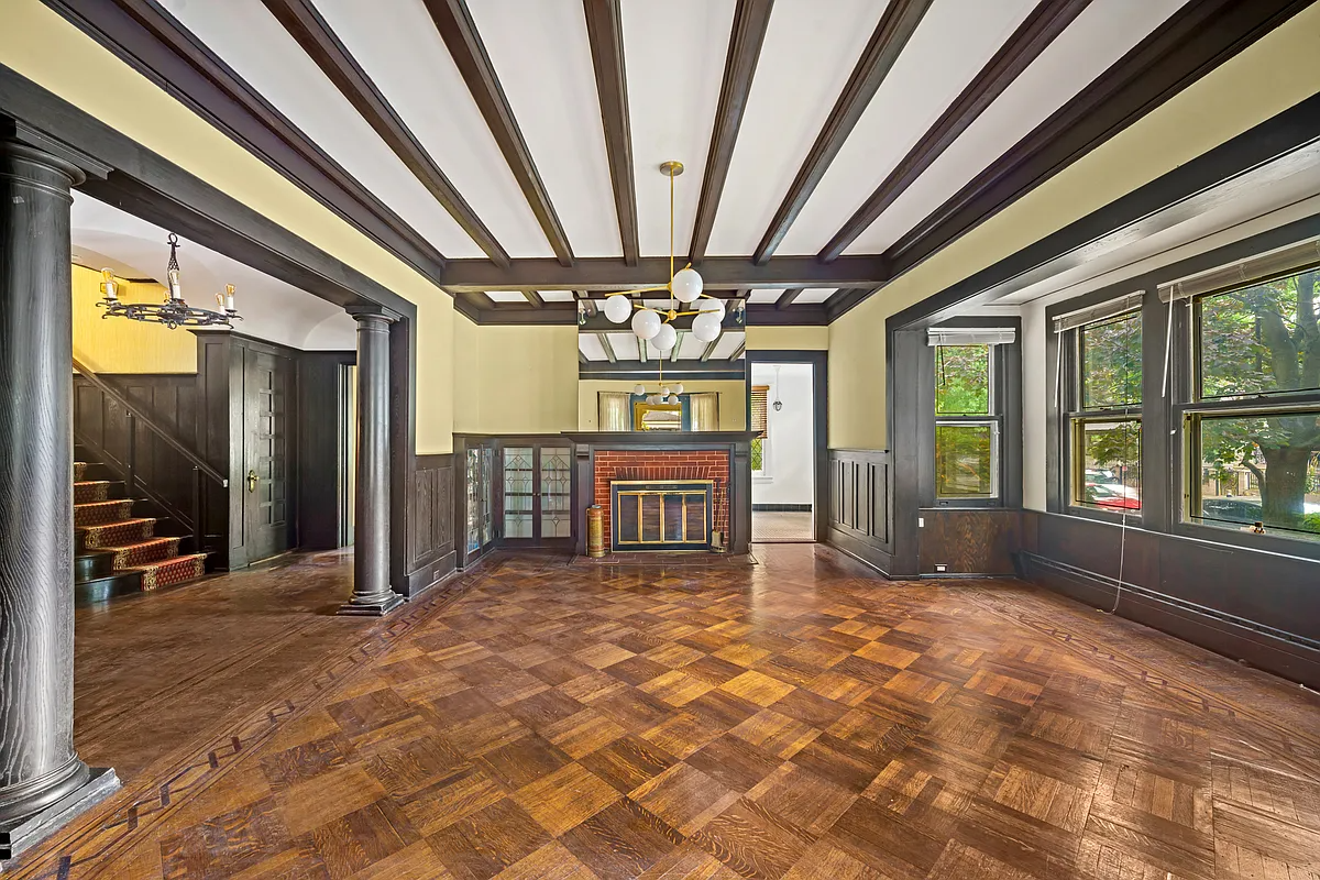 parlor with beamed ceiling, wood floor