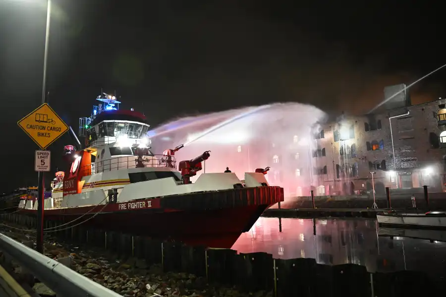 fireboat aiming water at the building
