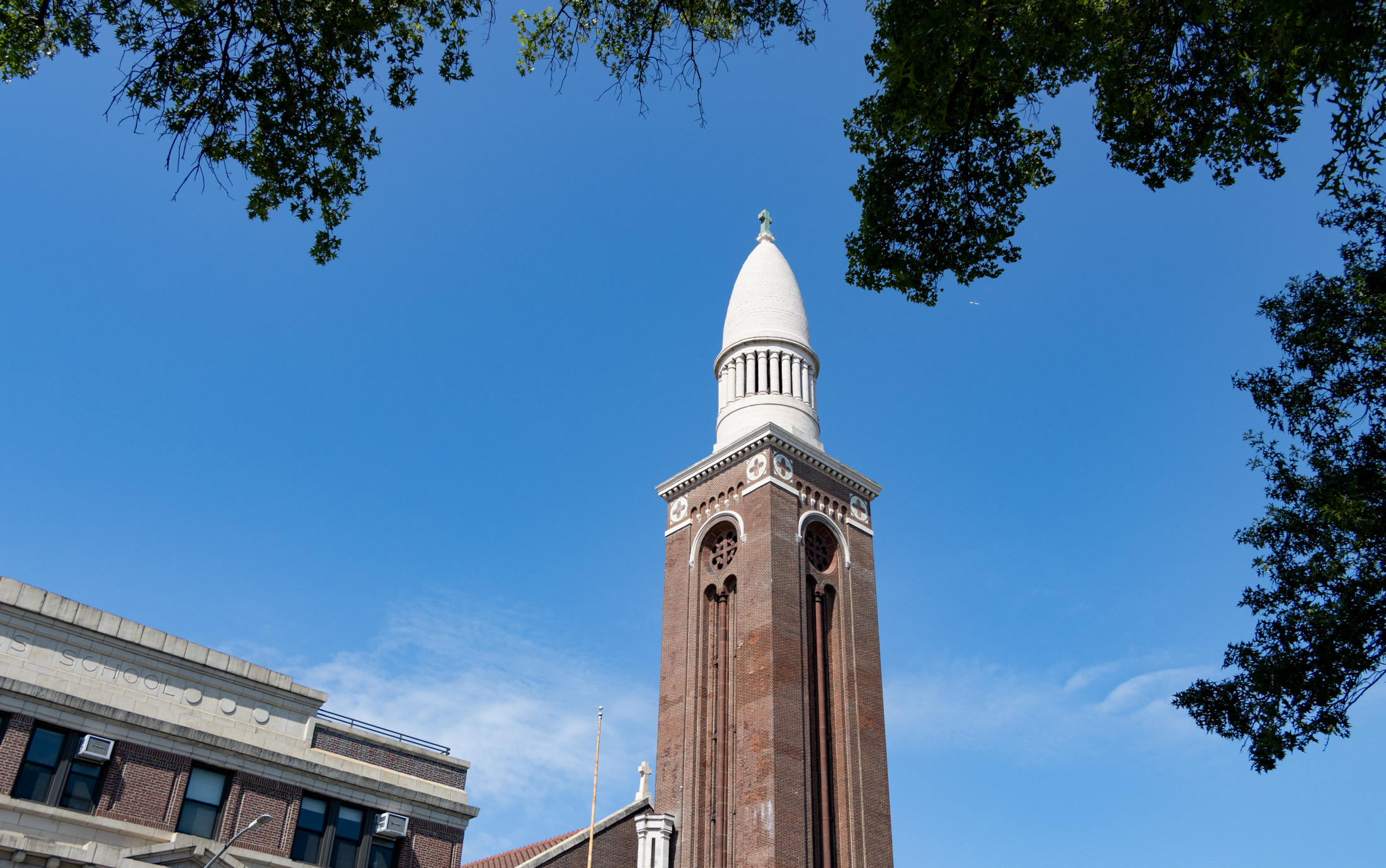 brick steeple against a blue sky