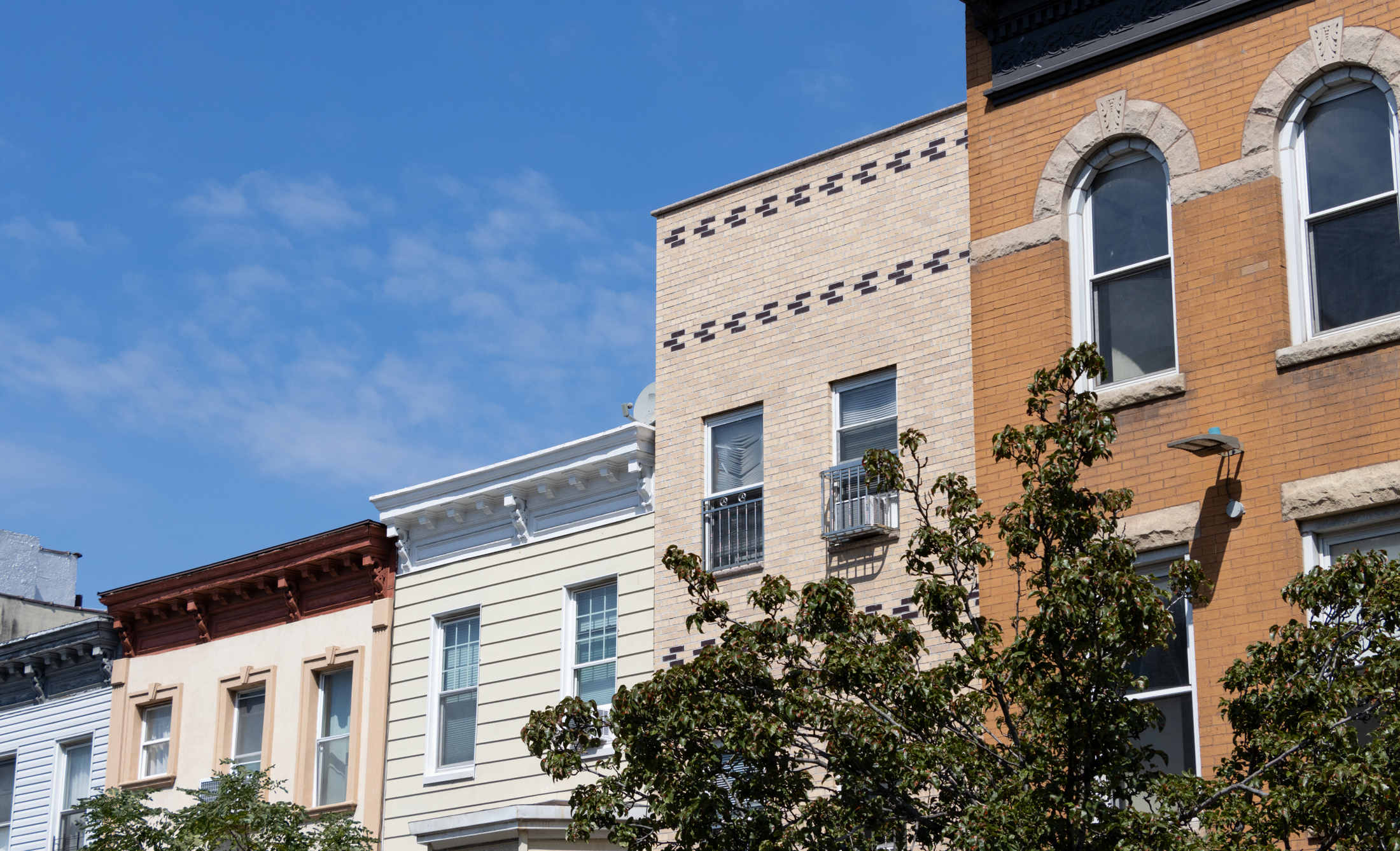 the rooflines of brick and wood frame buildings in sunset park
