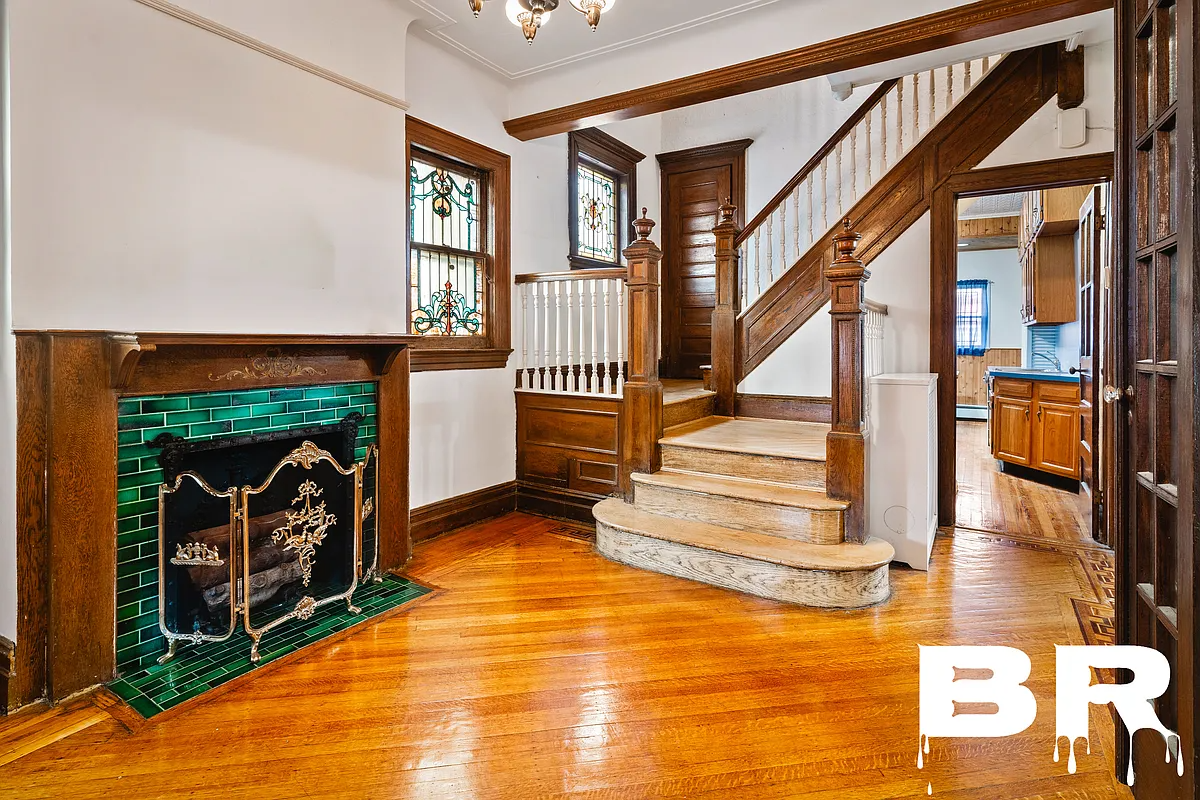 entry hall with mantel , stair and stained glass windows