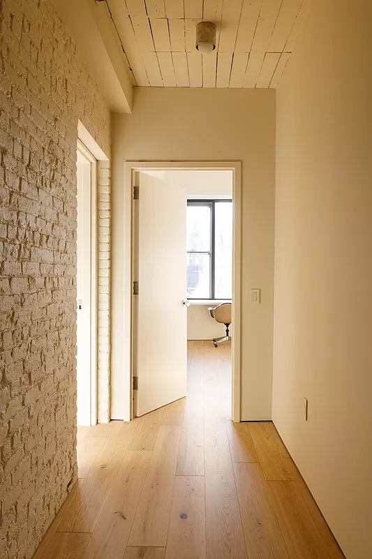hallway with exposed brick painted cream