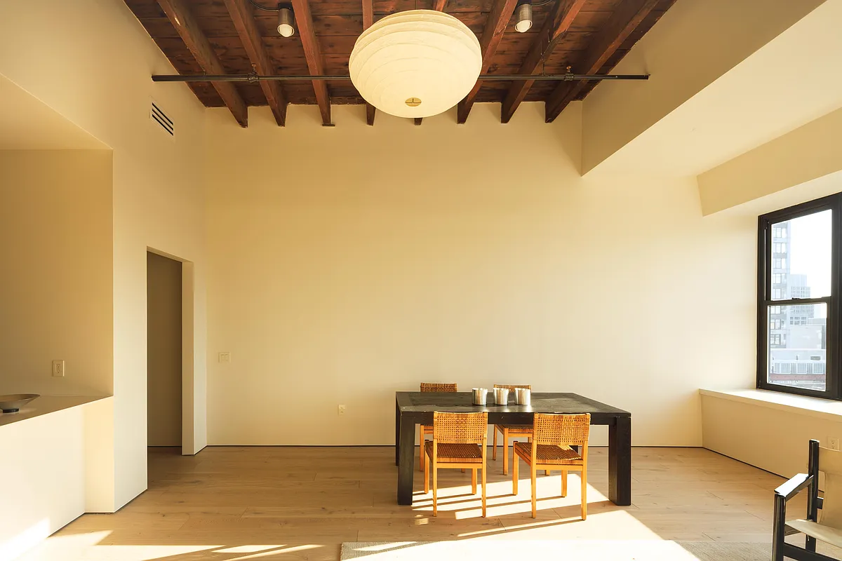 living room with exposed beams and room for a dining area