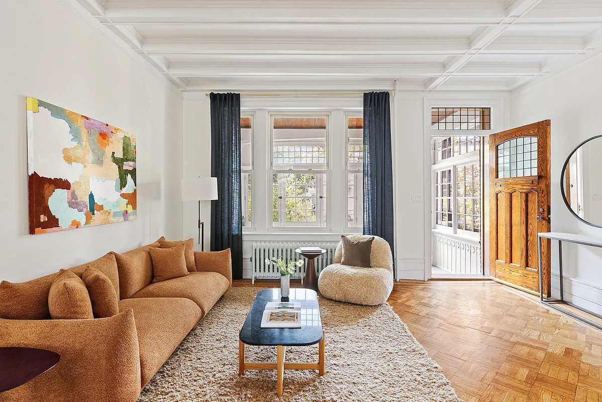 living room with wood floor, view into enclosed porch