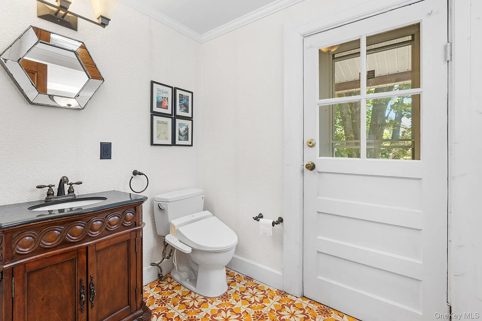half bath with pattered tile floor in orange and yellow