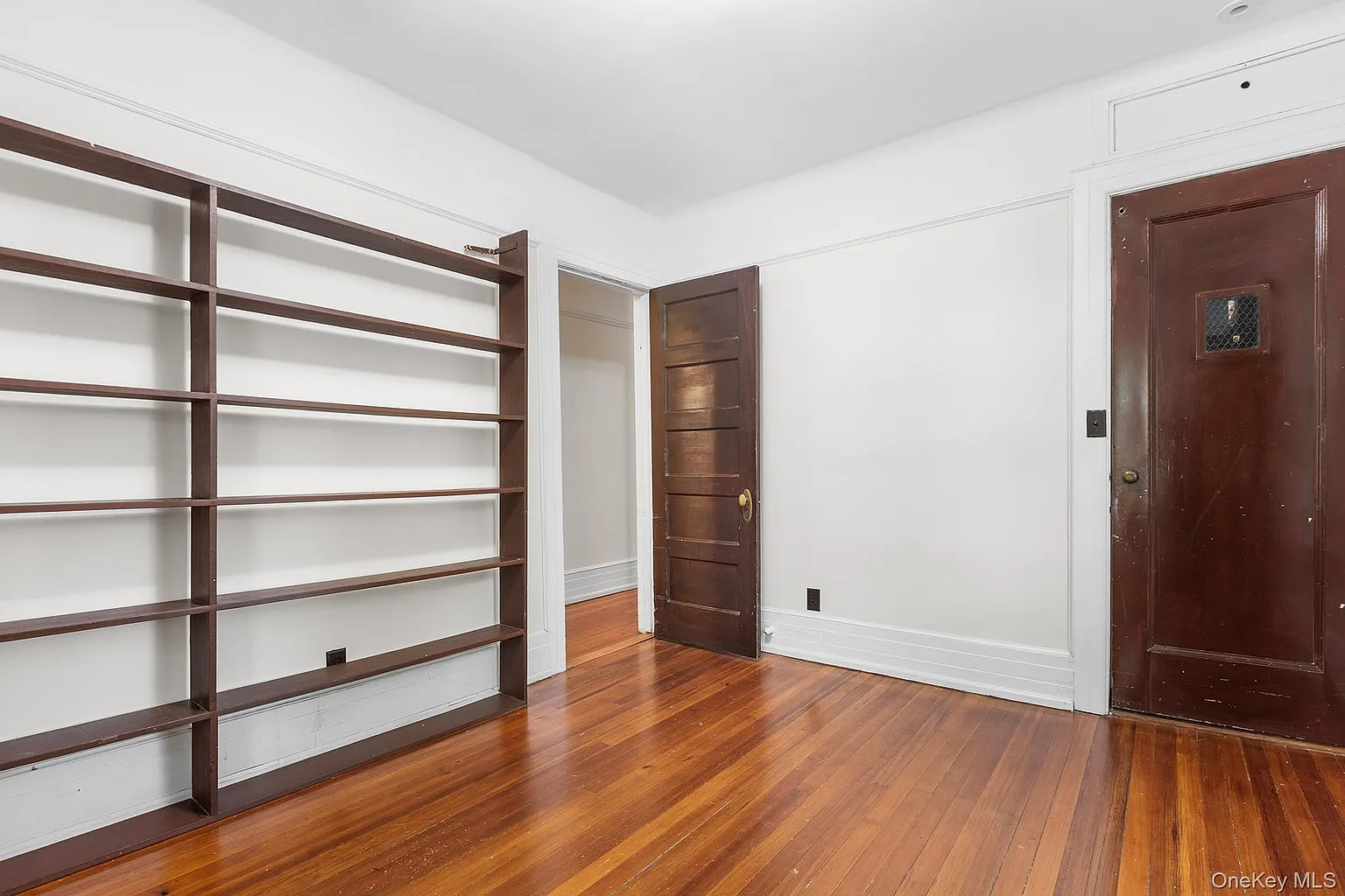bedroom with white walls, modern shelves