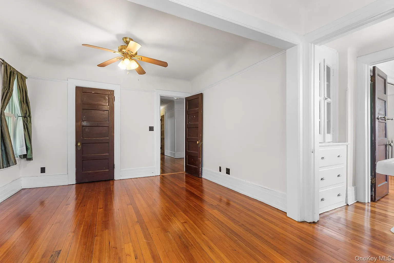 bedroom with view of built-in cabinets in a passthrough