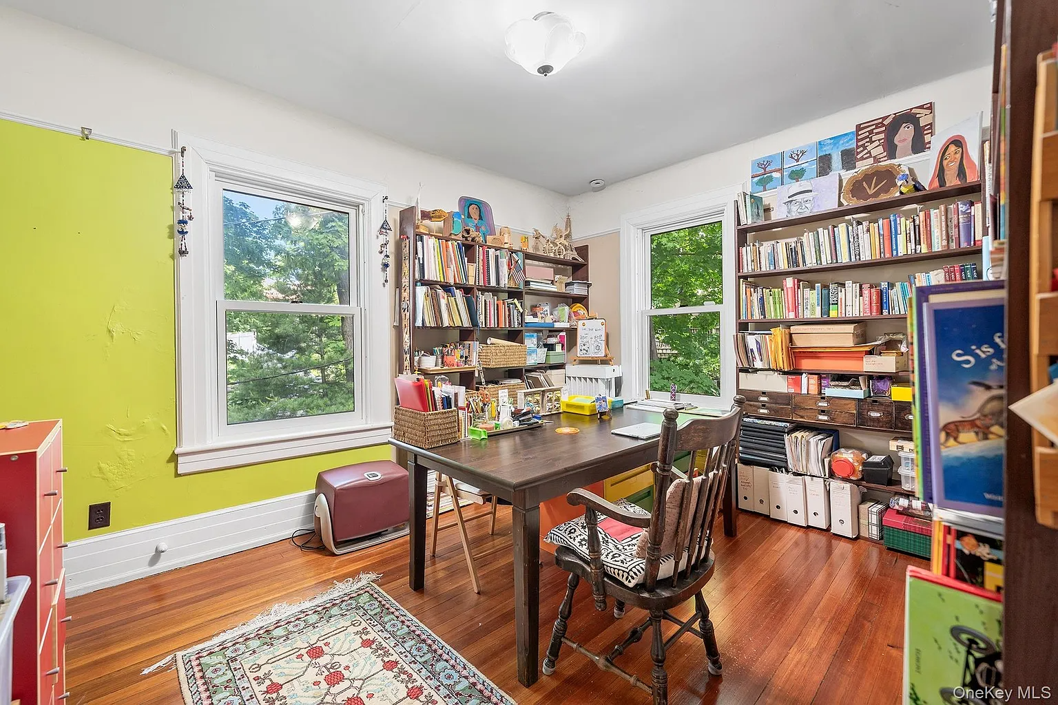 bedroom with yellow walls set up as an office