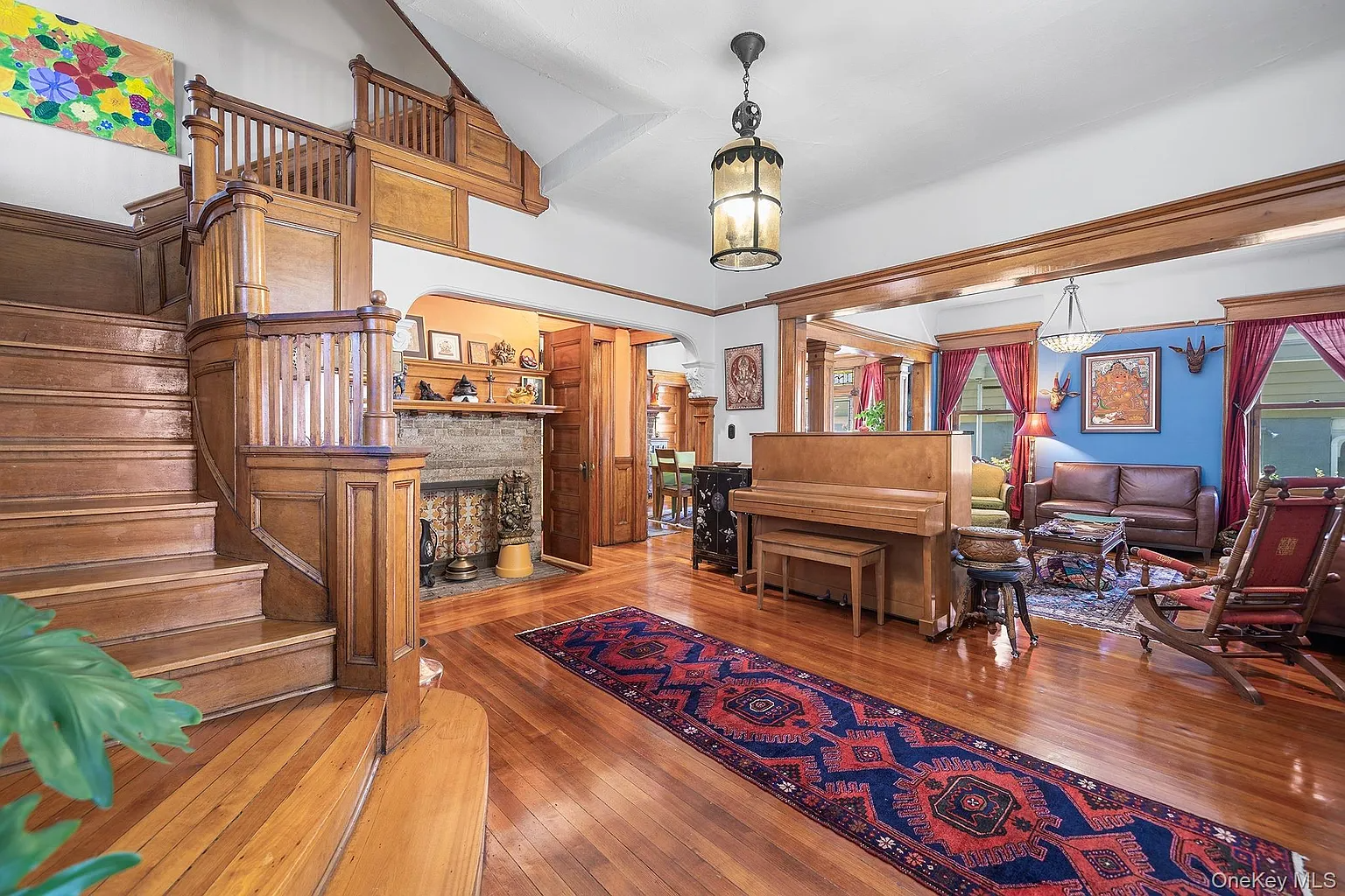 entry hall with wood stair, stained glass, fireplace