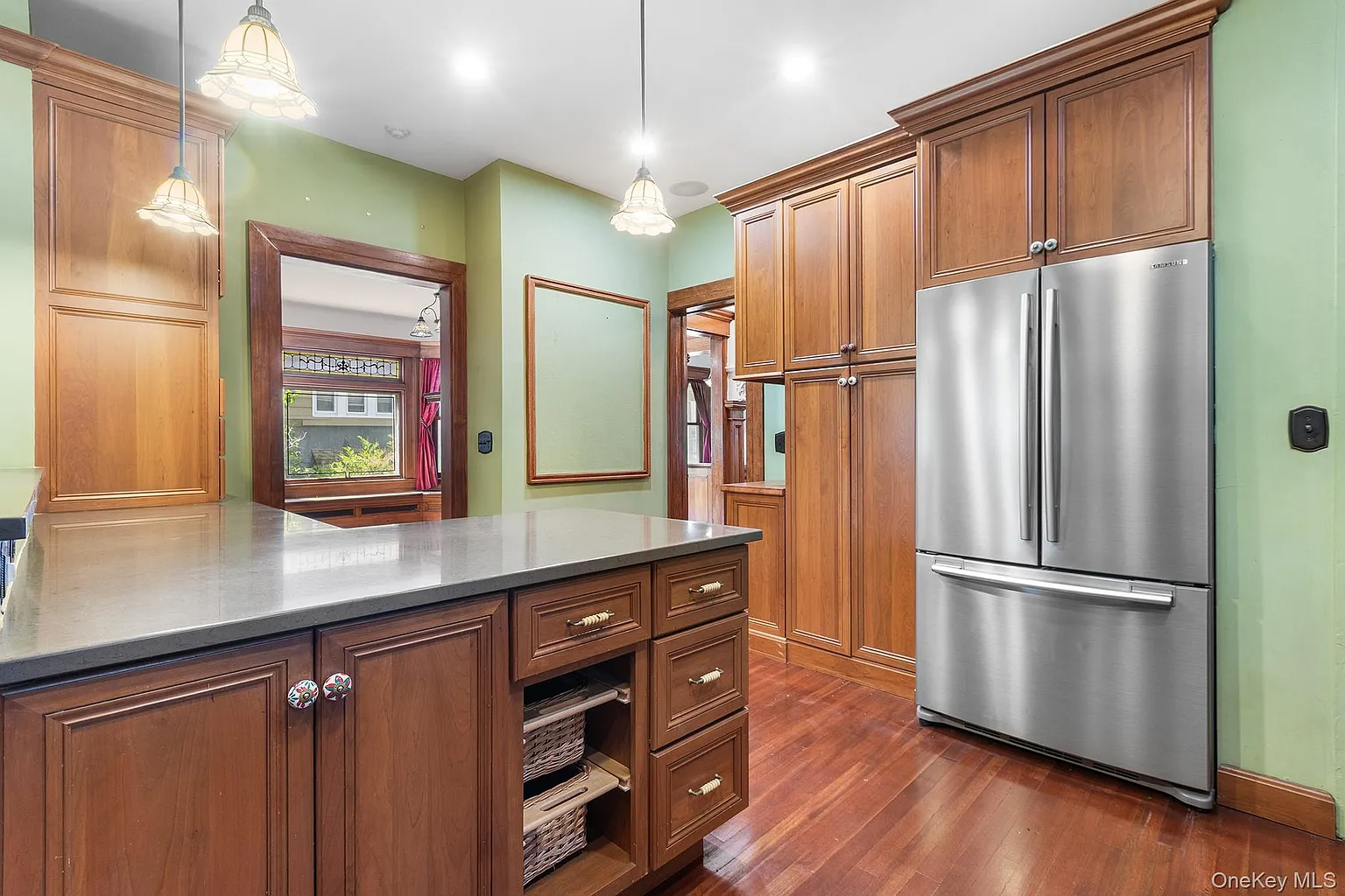 kitchen with green walls, green tile backsplash, wood cabinets