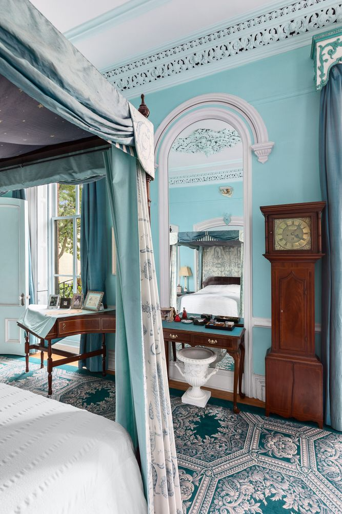 bedroom with an arched niched with a mirror