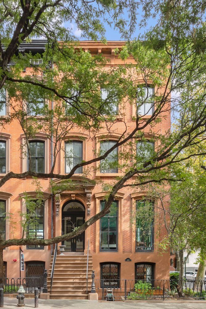 brick exterior with a brownstone stoop