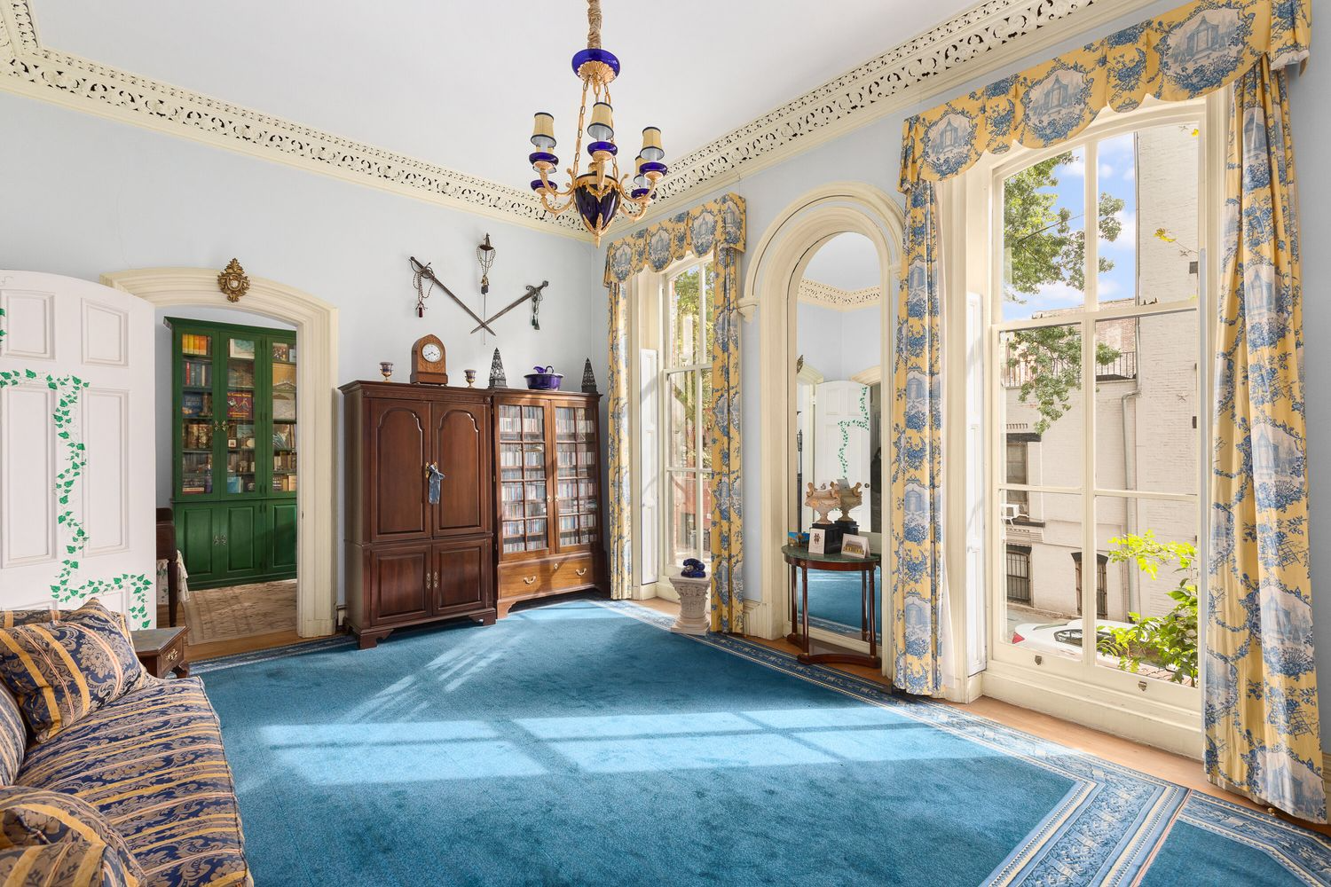 living room with intricate plasterwork, high ceilings, tall windows