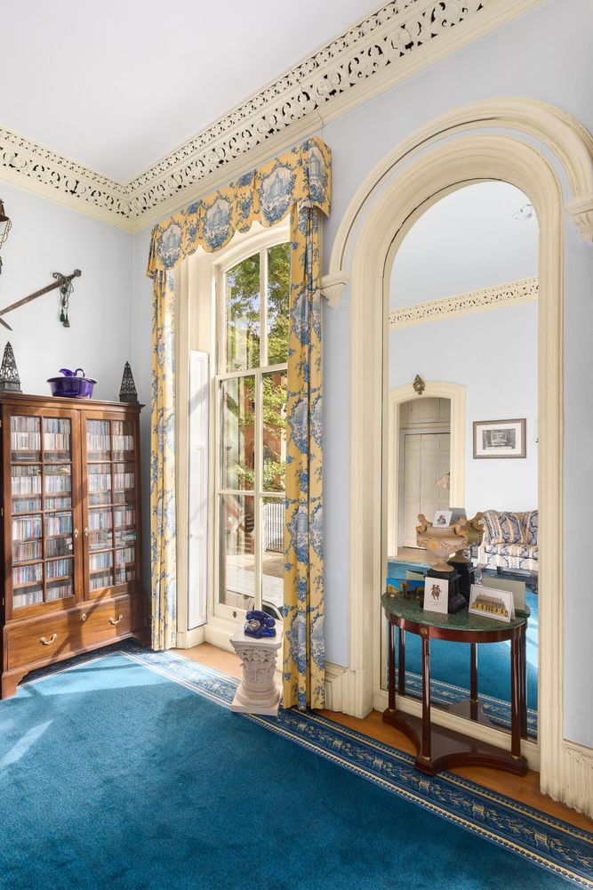 arched niche in the living room with a mirror installed