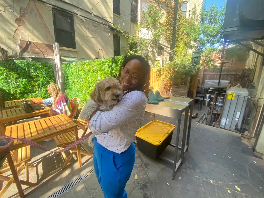 Tiffany Dockery holding a customers dog.