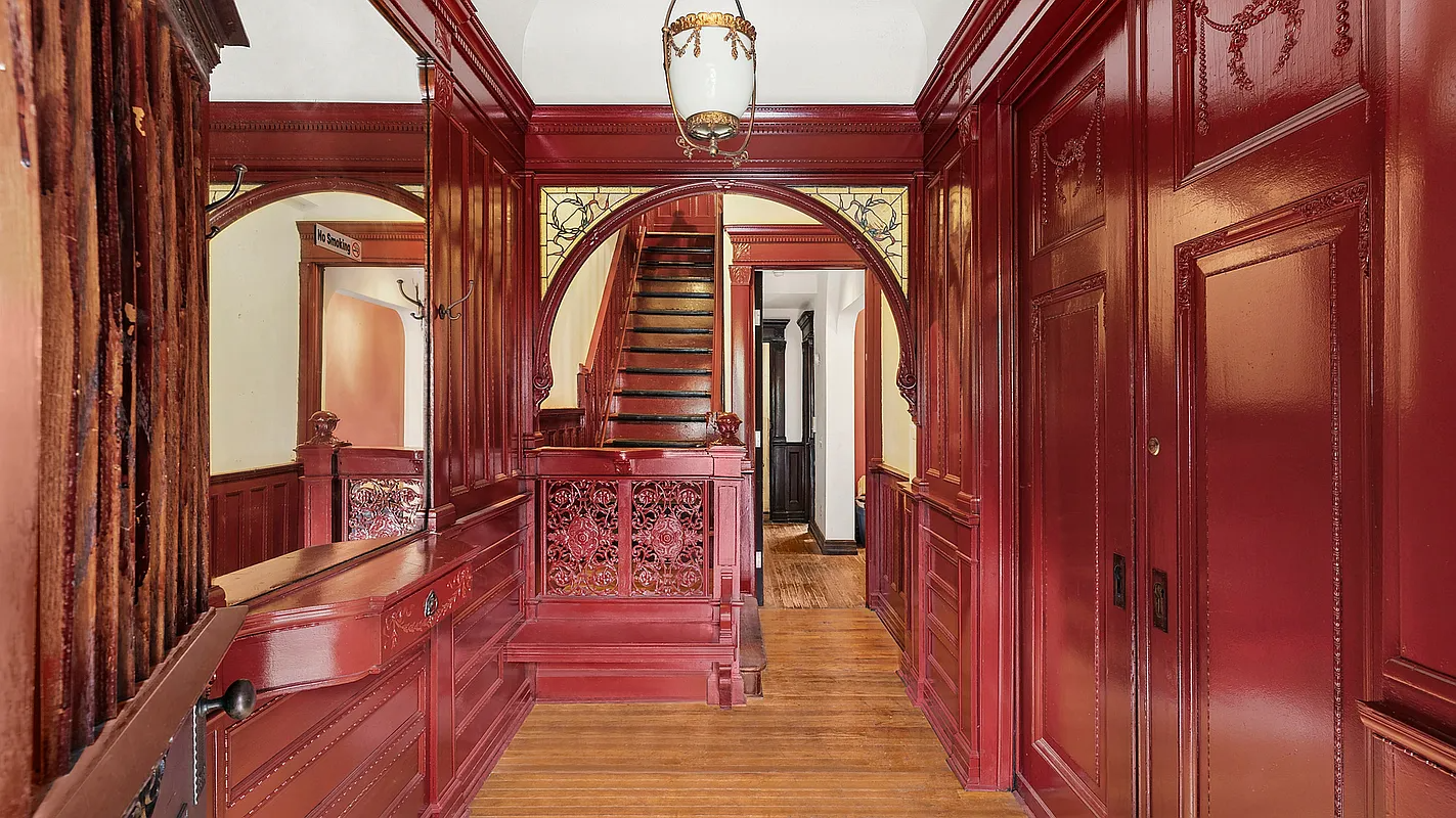 entry with woodwork, mirror, wood floor