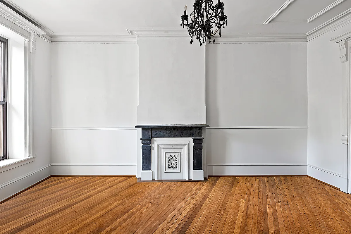 parlor with white walls, mantel