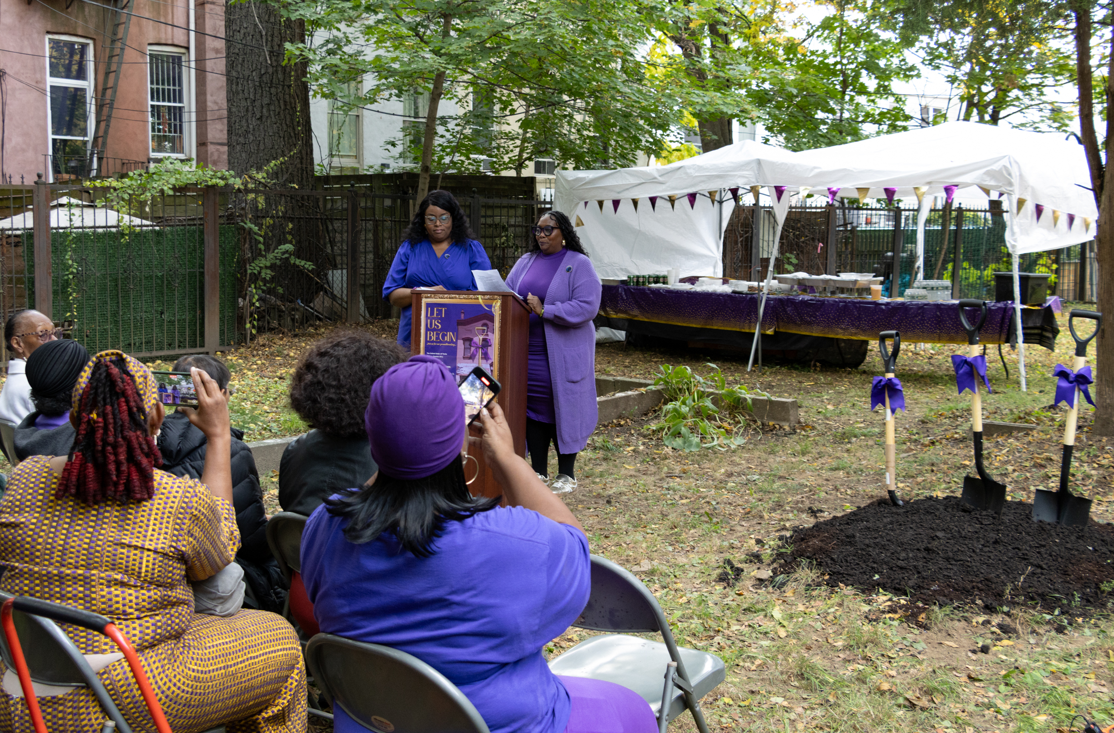 women in purple at podium